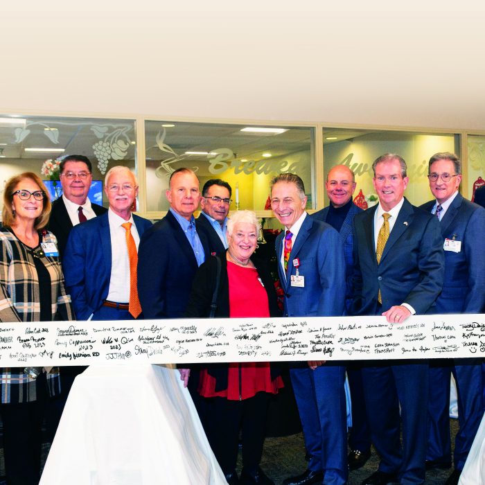 a group of people holding a steel beam
